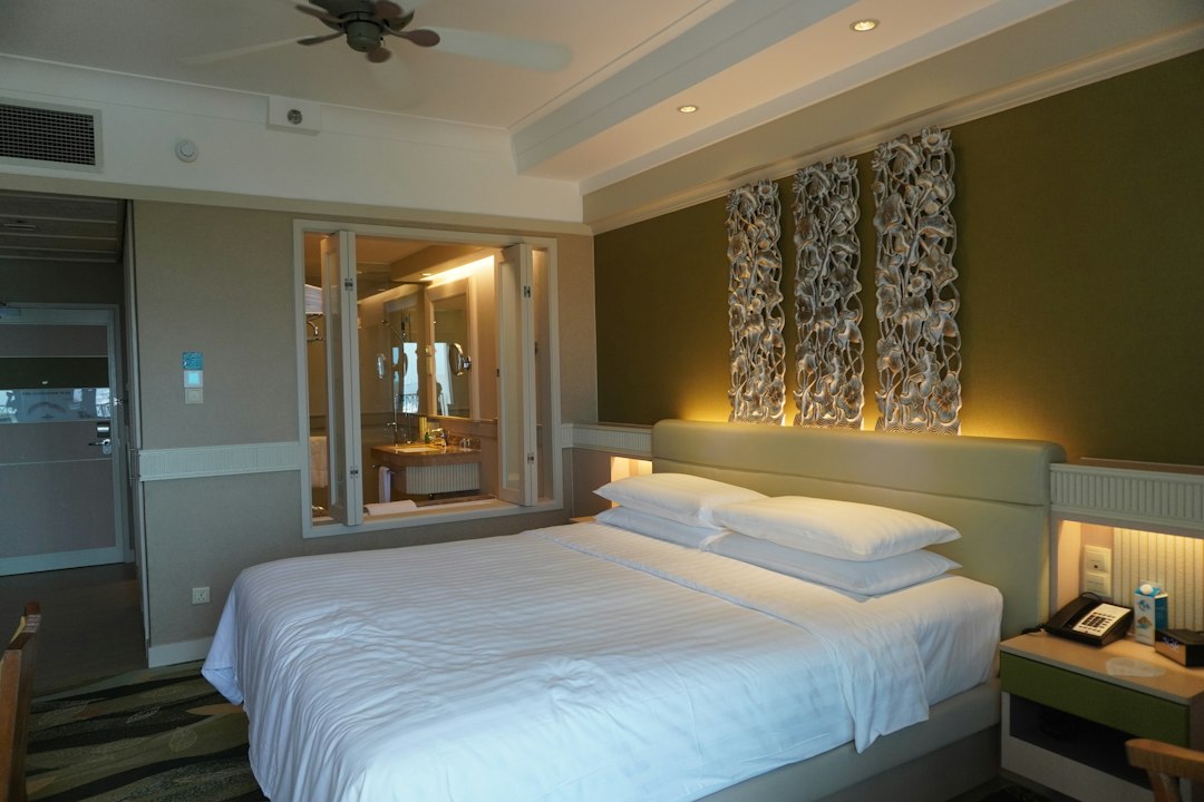 Hotel room interior with a made bed